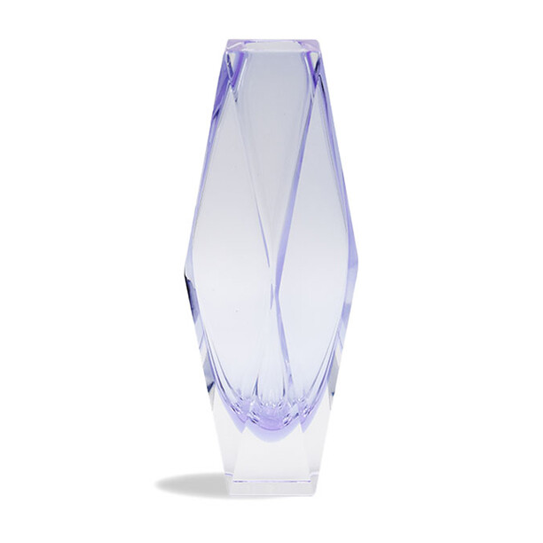 The image features a vase that is crafted from Murano glass, which is known for its intricate designs and high quality. The design of the vase is quite unique, with an asymmetrical shape featuring a flared opening on one side and a narrower opening on the other, resembling the shape of a flower or blossom. It has a translucent quality to it, allowing light to pass through in a way that highlights its texture and form. The color appears to be a pale blue or purple hue, with subtle variations and swirls typical of handcrafted glass pieces. This vase is likely made using traditional Venetian glassmaking techniques, which are renowned for their artistic expression and craftsmanship.