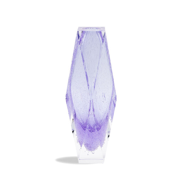 The image displays a striking piece of MURAN glass, which is known for its delicate and intricate designs. This particular item appears to be a vase with a slender neck and wide base, reminiscent of a classical form often associated with Venetian glasswork. The coloration is particularly noteworthy, featuring a deep, almost iridescent purple that suggests an inner light or depth. The design includes swirling patterns that give the impression of movement or fluidity, enhancing the vase's aesthetic appeal. These patterns are characteristic of blown glass, where artisans manipulate the molten glass to create unique shapes and textures. The background is neutral, which brings attention to the vase as the central focus of the image. The photograph is taken from a slightly elevated angle, showcasing the profile of the vase while allowing for a view of its base. The overall composition emphasizes the craftsmanship and artistry inherent in such pieces. Keywords: MURAN glass, glass, vase, lamp MURAN glass, design, made in Italy, Venice glass