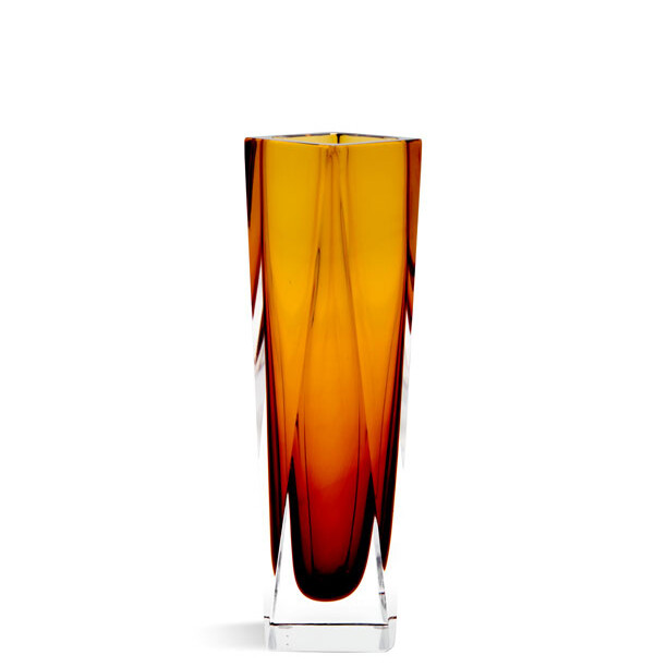 The image showcases a striking piece of Murano glass. It's a tall, slender vase with an elongated neck and a narrow base. The color palette is quite captivating, featuring shades of amber and gold that create a mesmerizing interplay of hues reminiscent of a sunset or molten lava. The craftsmanship of this piece is evident in the way the colors blend and swirl within the glass, each band or stripe of color having its own distinct character yet contributing to the overall aesthetic harmony of the vase. The transparency of the glass allows for light to pass through, further enhancing the visual experience. This piece is a testament to the artistry of Murano glassmaking, which has been practiced in Venice, Italy, for centuries. The intricate design and the way the colors are layered within the glass are indicative of the skilled techniques employed by Murano glass artists, known as 