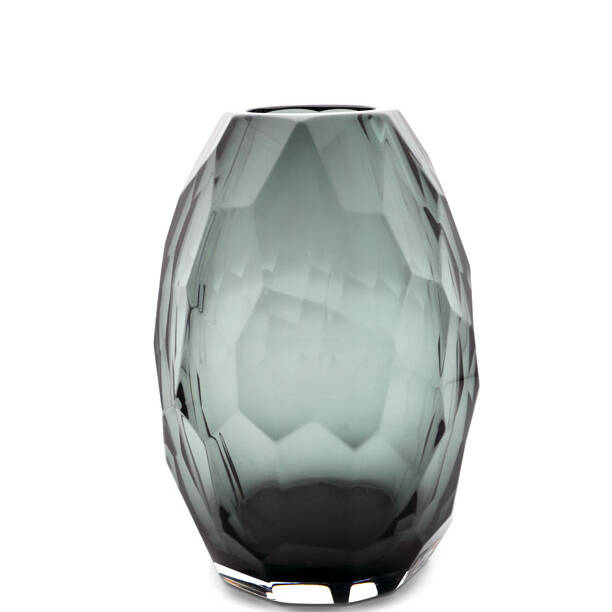 The image showcases a Murano glass vase, characterized by its unique design and the artisan craftsmanship that is typical of this renowned Italian glass. The vase has an elegant shape with a flared top and a narrower base, creating a sense of balance and grace. It features a textured surface that adds depth and interest to the piece, reflecting light in a way that enhances its beauty. The color is a rich, deep teal or turquoise, which contrasts subtly with the golden-brown tones often associated with Murano glass. The transparency of the glass allows for intricate patterns within it, hinting at the layers and swirls created by the artist during the blowing process. This kind of vase would be a centerpiece in any interior setting due to its striking appearance and artistic value. The background is minimalistic, with two neutral shades that complement the vivid color of the vase without overpowering it, allowing the focus to remain on the piece itself. The colors used are also reminiscent of Venetian architecture, further emphasizing the Italian origin of this glassware. The text 