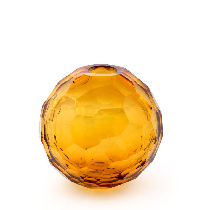 The image shows a round, golden-yellow glass sculpture with a textured pattern. It appears to be made of Murano glass, as indicated by the reference to 