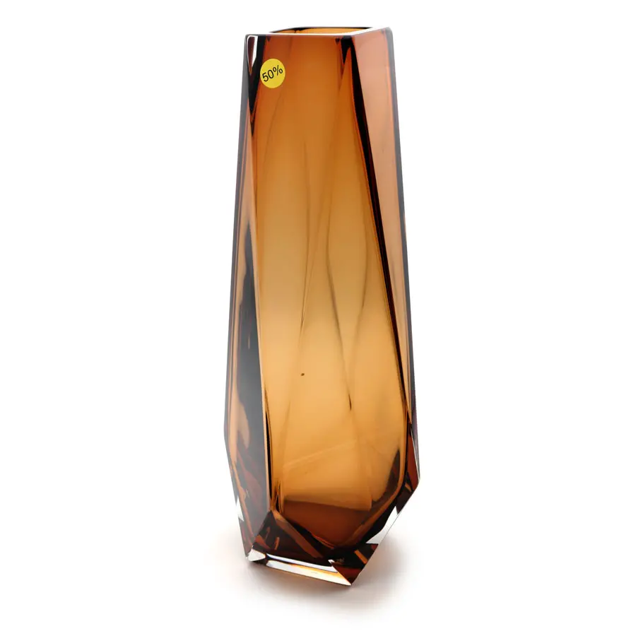 Elegant handcrafted vase, boasting a unique diamond-like shape in warm golden hues with mesmerizing light refraction and facets that catch the eye.